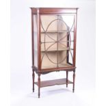 A Maple & Co Edwardian mahogany display cabinet, with astragal glazed door enclosing two fabric