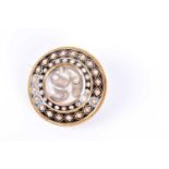 A Victorian yellow gold, pearl, and black enamel mourning broochof circular form, centred with a