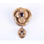 A Victorian yellow gold and garnet broochof knotted design, the mount with engraved decoration and
