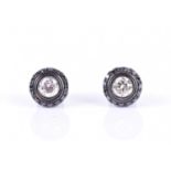 A pair of 18ct black gold, and black and white diamond halo stud earrings each centred with a
