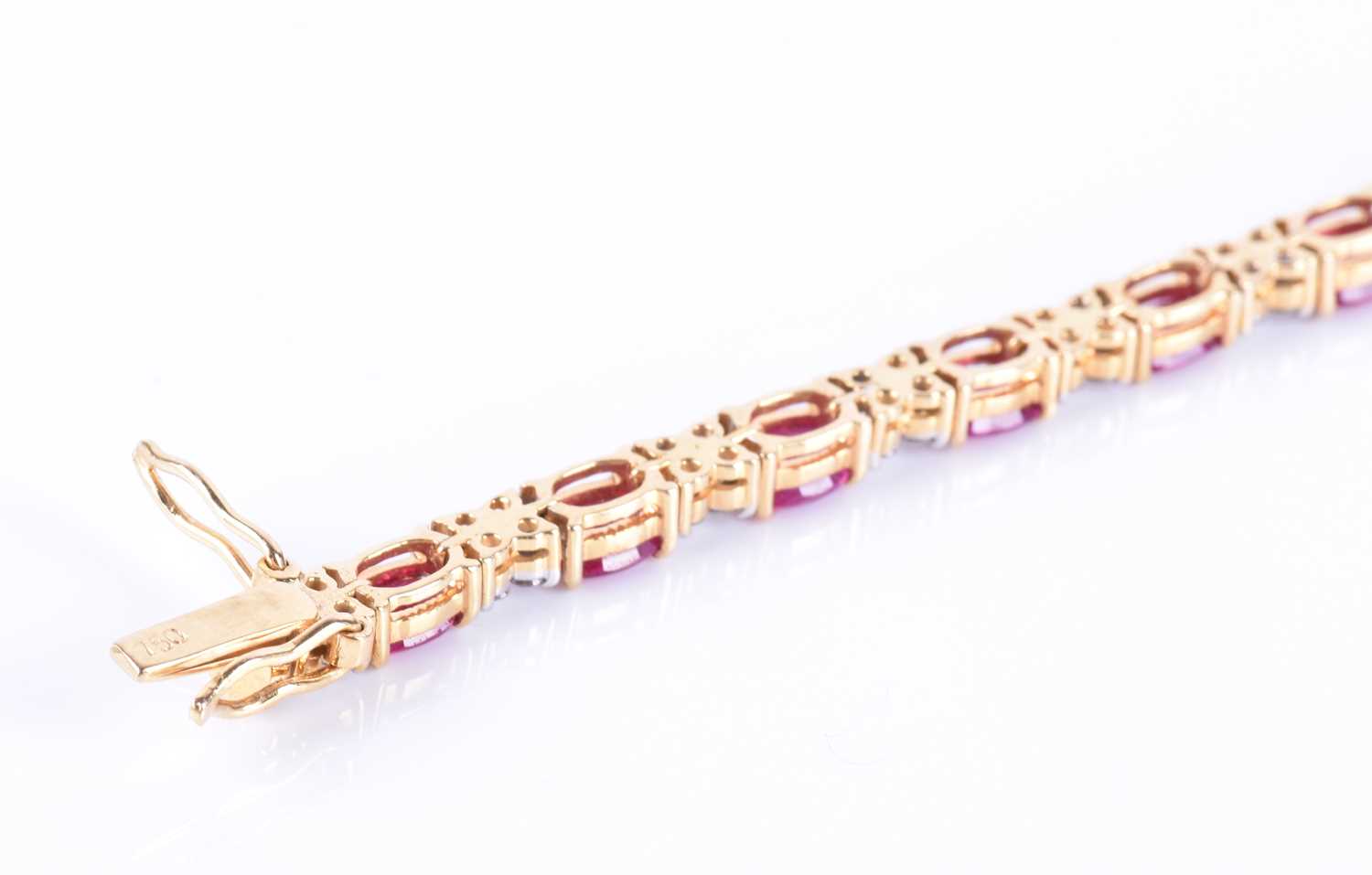 A fine 18ct yellow gold, diamond, and ruby line braceletset with nineteen mixed oval-cut rubies - Image 5 of 5