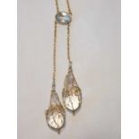 A 9ct gold necklace with faceted pendant drops, the clear pear shaped drops bound in gold wire