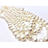 A 7.5-8mm white/ cream knotted Freshwater pearl strand. 149 cm long.