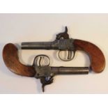 A pair of 19th century percussion pistols, the round barrels with indistinct proof marks, the box
