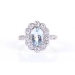 An 18ct yellow gold, diamond, and aquamarine cluster ringset with a mixed oval-cut aquamarine of