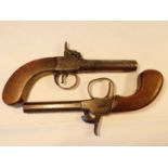Two early 19th century percussion pistols. one with round barrel with indistinct proof marks and