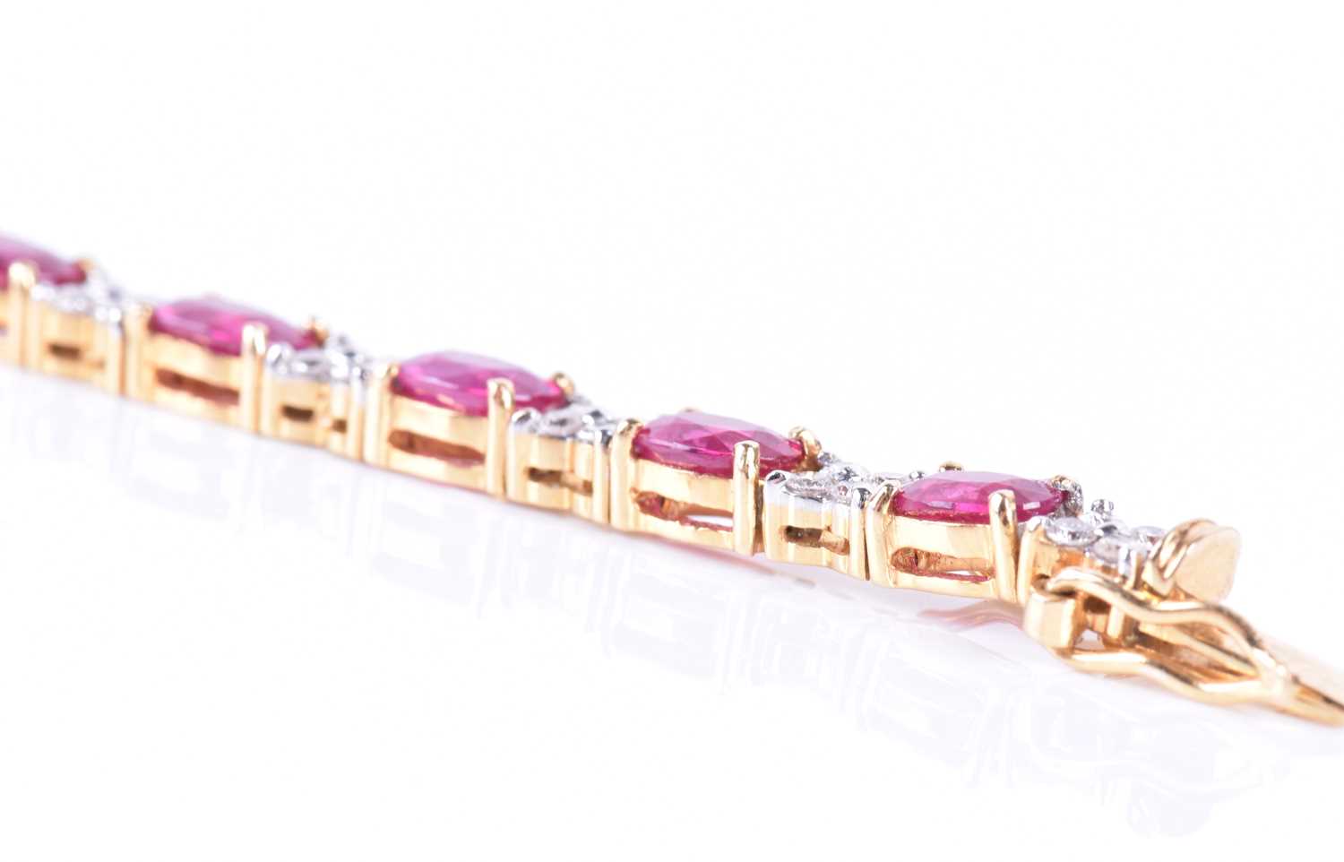 A fine 18ct yellow gold, diamond, and ruby line braceletset with nineteen mixed oval-cut rubies - Image 4 of 5