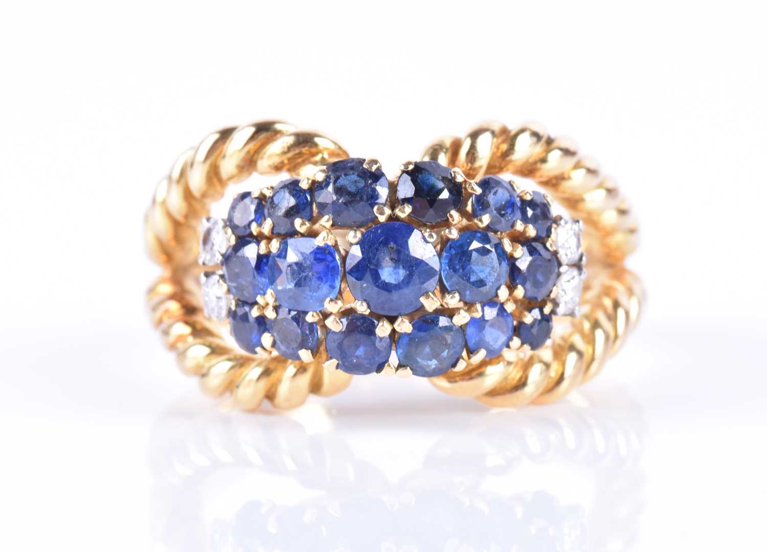 An 18ct yellow gold and sapphire bombe-style ringthe double rope-twist mount set with a cluster of