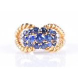 An 18ct yellow gold and sapphire bombe-style ringthe double rope-twist mount set with a cluster of