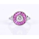 A diamond and ruby target ring, in the Art Deco style, centred with a round brilliant-cut diamond,