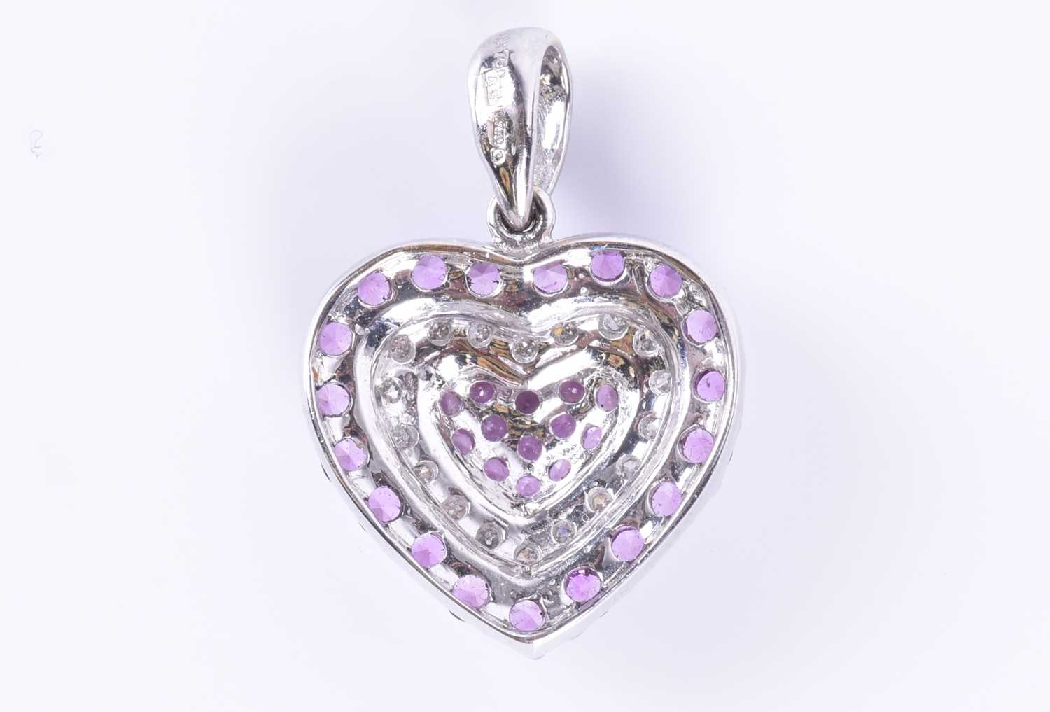 An 18ct white gold, diamond, and pink sapphire pendantof heart-shaped form, set with round-cut - Image 2 of 3