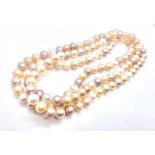 An 8-8.5mm Pink, cream and light grey freshwater pearl strand. 99 cm long.