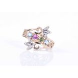 A 9ct yellow gold, diamond and multi-coloured gemstone ringthe crossover mount set with blue, green,