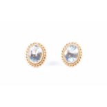 A pair of 18ct yellow gold and aquamarine stud earringseach set with a mixed oval-cut aquamarine