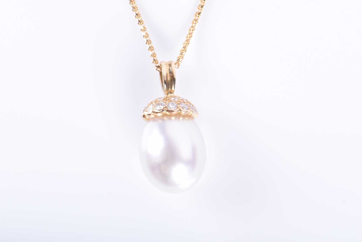 A diamond and South Sea pearl pendantthe oval rounded pearl set beneath a yellow metal and diamond