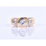 A yellow metal and diamond ring, collet-set with a round-cut diamond of approximately 0.50 carats,