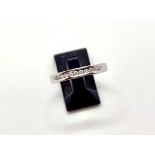 An 18ct white gold diamond 2.8mm wide band. 11 Chanel set brilliant cut diamonds of I colour and