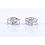 A pair of diamond earrings, of curved design, centred with a small cluster of round-cut diamonds,