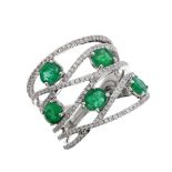 Frost of London. An 18ct white gold, emerald and diamond dress ring, setr with emeralds weighing 1.