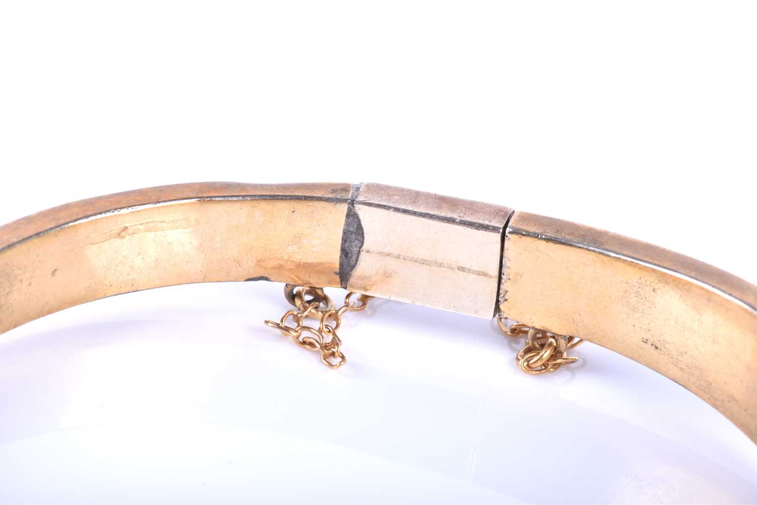 A late Victorian garnet bracelet, the gilt metal hinged bangle set with five collet-set rose-cut - Image 2 of 8
