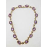 A 9ct gold and Amethyst set necklace, the facet cut amethysts ingold beaded mountsinterspersed by