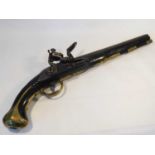 An 18th century flintlock pistol, the carved wood stock with brass mounts, trigger guard and butt