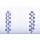 A fine pair of 18ct white gold, diamond, and sapphire drop earringseach set with three rows of