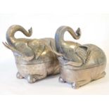 A near pair of Cambodian white metal Elephant form betel leaf boxes, each in recumbent pose with