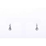 A pair of white metal and diamond drop earringspossibly French, each with a smaller and larger