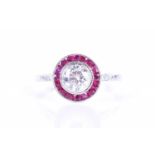 A diamond and ruby target ring in the Art Deco stylecentred with a round brilliant-cut diamond of