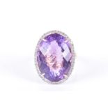 A 14ct yellow gold, diamond, and amethyst cocktail ring set with a large faceted amethyst of