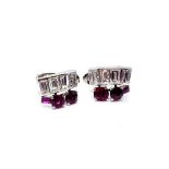 A pair of ruby and diamond earrings. two round and one rectangular rubies per earring and 4 baguette