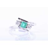 A diamond and emerald crossover ringcentred with a mixed square-cut emerald flanked with two round