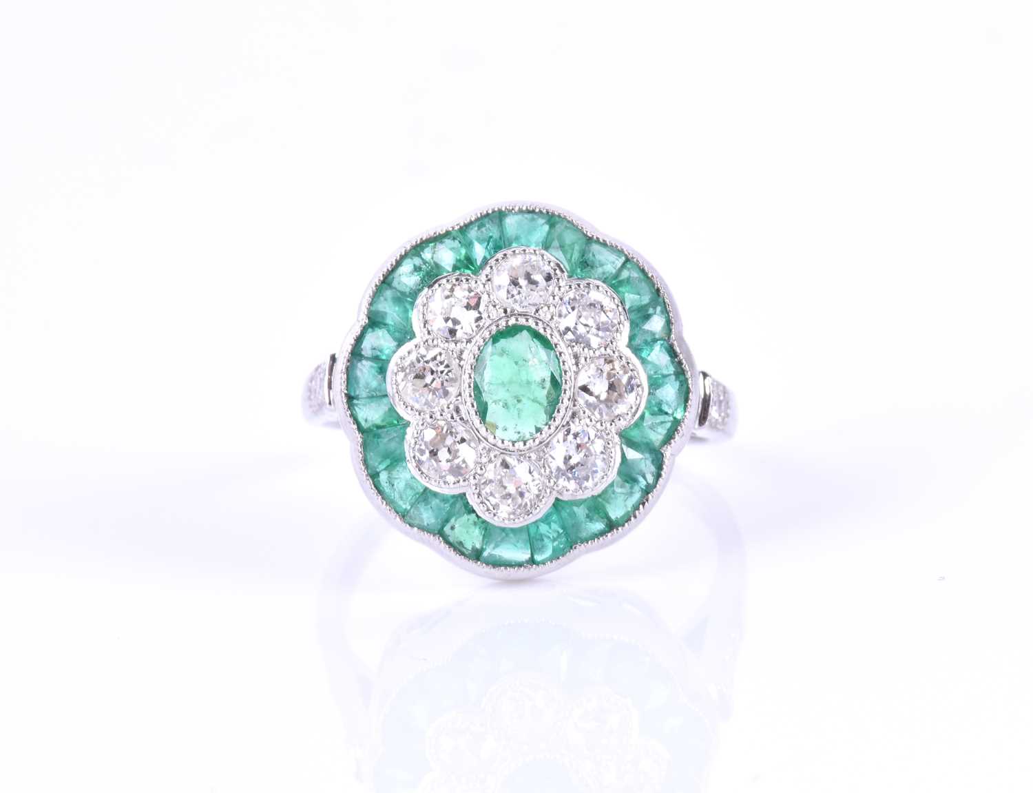 A diamond and emerald cocktail ringcentred with a mixed oval-cut emerald, within a border of round - Image 4 of 5