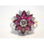 An 18ct gold diamond and synthetic ruby daisy cluster ring, with yellow metal shank, size M/N, 7.5