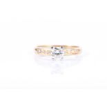 An 18ct yellow gold and diamond ringcentred with a round brilliant-cut diamond of approximately 0.45