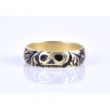An unusual 18ct yellow gold and black enamel eternity band ring, engraved with Momento Mori style