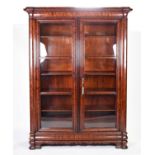 A large 19th century flame mahogany bookcase, with twin glazed doors and internal shelving, 192 cm x