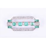 An Art Deco diamond and emerald broochthe rectangular mount inset with twelve emeralds (likely of