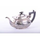 A George V silver teapot, R F Mosley, Sheffield 1913m the gadrooned and shell rim above a part