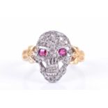 A yellow metal, silver, and diamond 'skull' ringthe silver skull inset with ruby eyes and pave-set