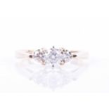 A 14k yellow gold and three stone diamond ringset with a round brilliant-cut diamond of