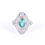 A diamond and emerald cocktail ringin the Art Deco style, the oval mount centred with a mixed oval-