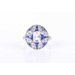 An 18ct white gold, diamond, and sapphire ringcentred with an oval-cut diamond of approximately 1.05