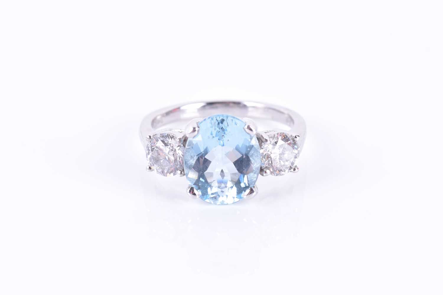 A platinum, diamond, and aquamarine ringset with a mixed oval-cut aquamarine of approximately 3.0