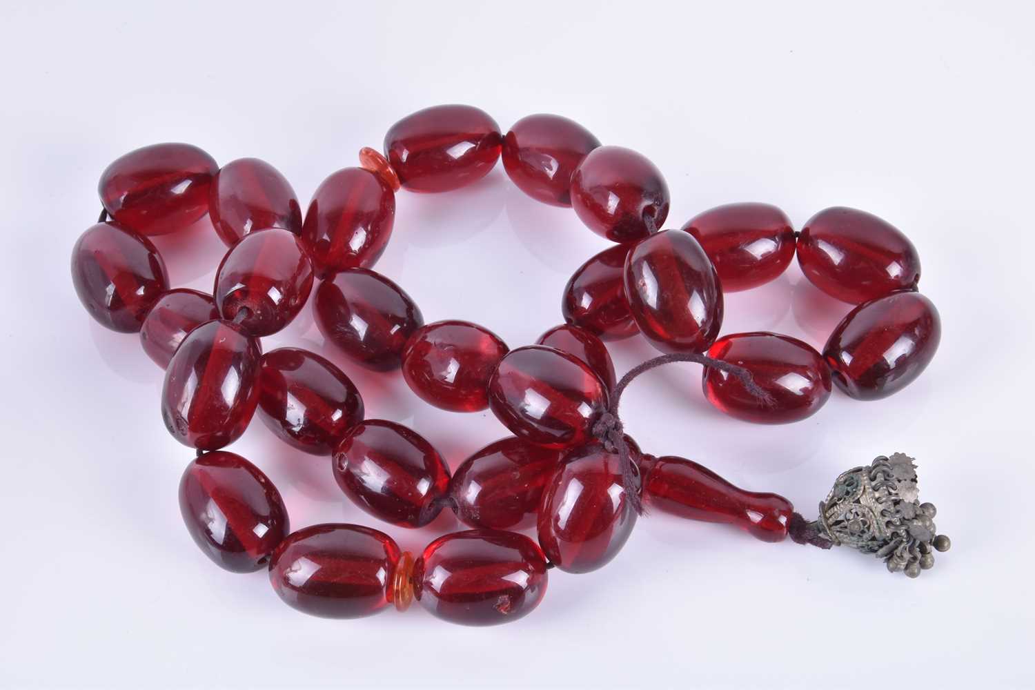A large amber prayer bead necklacecomprised of cherry amber beads, each bead approximately 4 cm