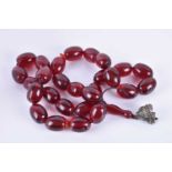 A large amber prayer bead necklacecomprised of cherry amber beads, each bead approximately 4 cm