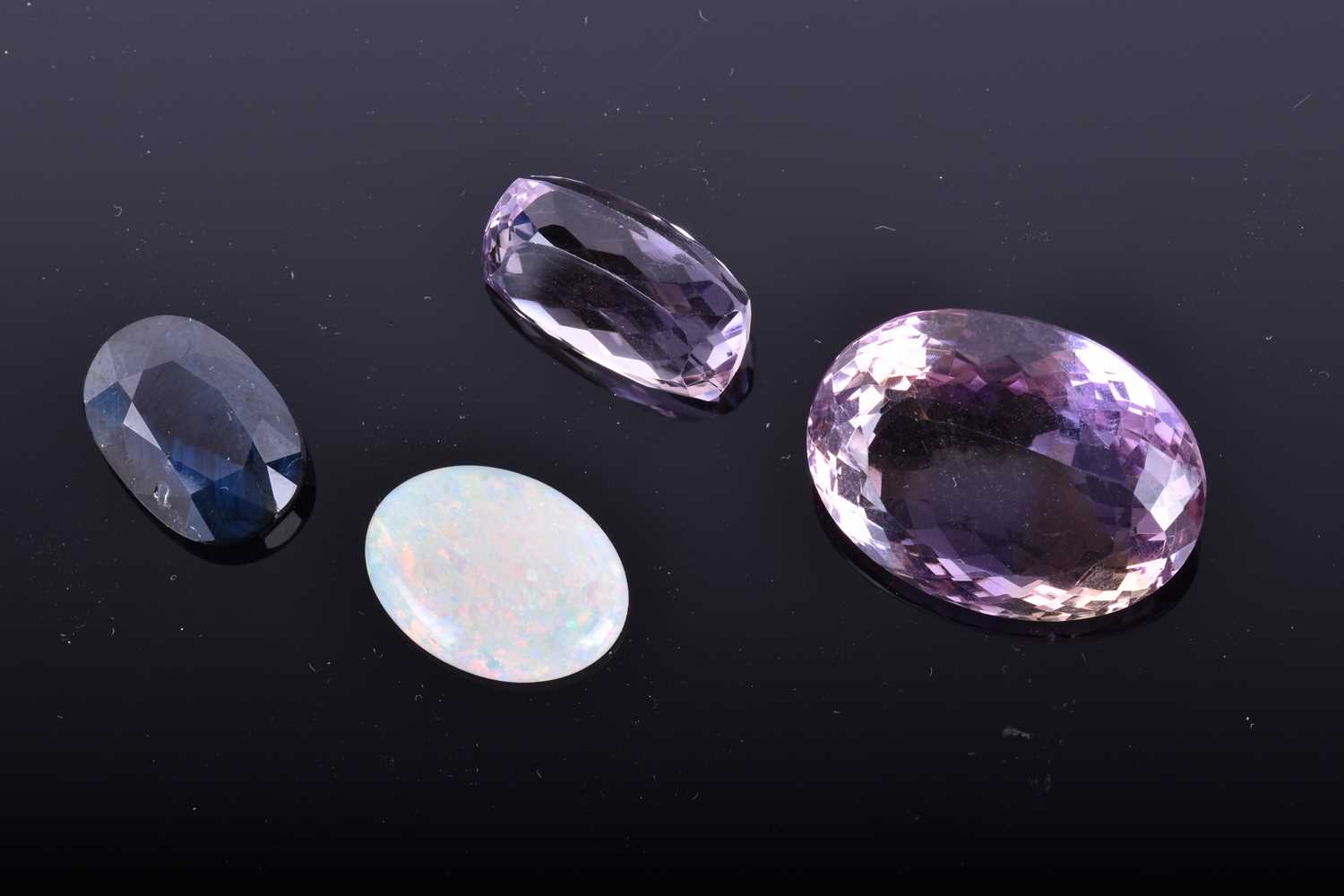 A loose mixed oval-cut sapphireof 9.80 carats (opaque, treated), together with a 28.15 carat mixed