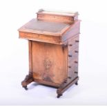 A Victorian walnut and marquetry inlaid Davenport with brass gallery above stationery compartments