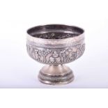 An Indian white metal pedestal bowl, late 19th century, repousse with a continuous band of